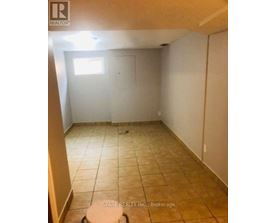 A room with tiled flooring and a window.