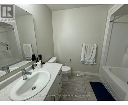 A white bathroom with a sink, toilet, and bathtub.