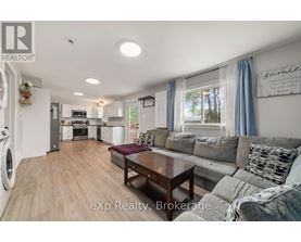 A modern kitchen with a dining area and a living room.