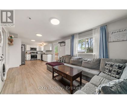 A modern kitchen with a dining area and a living room.