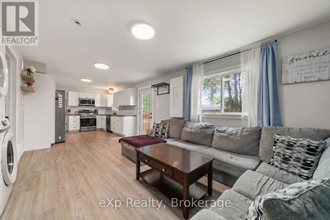 A modern kitchen with a dining area and a living room.
