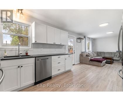 A modern kitchen with white cabinets and a large island.