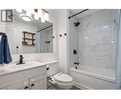 A bathroom with a toilet, sink, and bathtub.