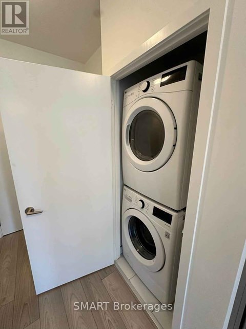A washing machine is built into a wall in a laundry room.
