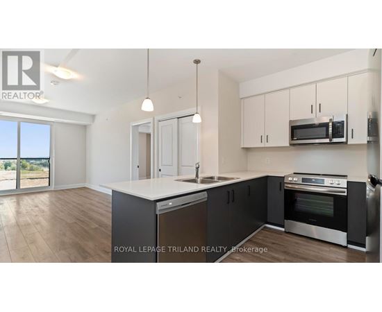 A kitchen with a large island and stainless steel appliances.