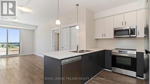 A kitchen with a large island and stainless steel appliances.