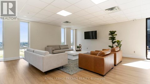 A living room with a flat screen TV mounted on the wall.