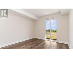 A room with a sliding glass door leading to a grassy area.