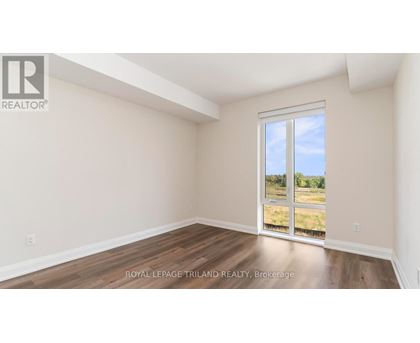 A room with a sliding glass door leading to a grassy area.