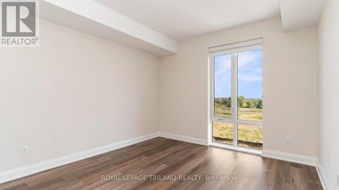 A room with a sliding glass door leading to a grassy area.