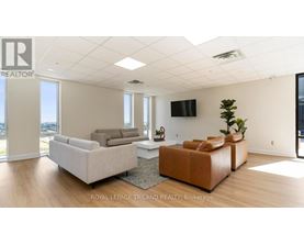 A living room with a flat screen TV mounted on the wall.