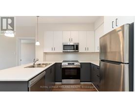 A modern kitchen with stainless steel appliances and white cabinets.