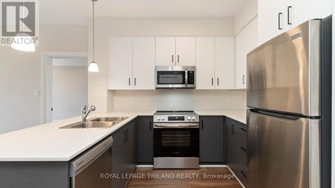 A modern kitchen with stainless steel appliances and white cabinets.