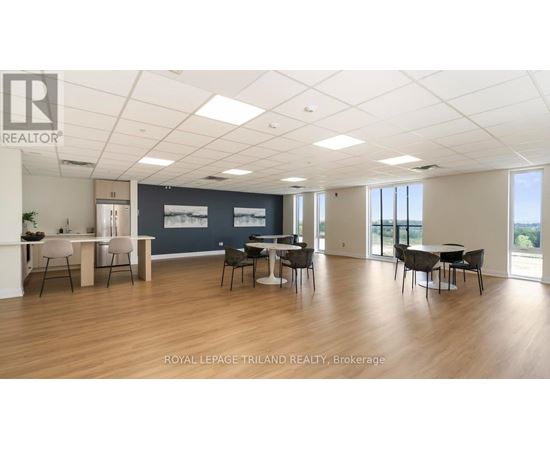 A spacious office room with a desk and chairs.