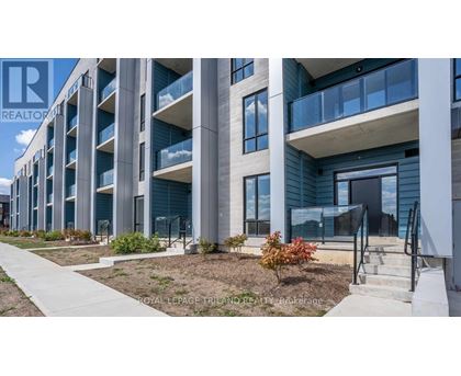 A modern building with a balcony and a sign that says "REALTOR".