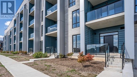 A modern building with a balcony and a sign that says "REALTOR".