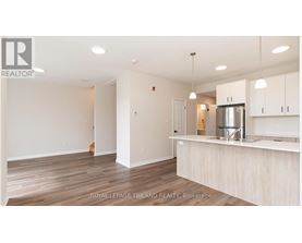 A kitchen area with a counter and cabinets.