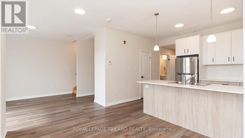 A kitchen area with a counter and cabinets.