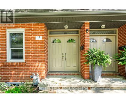 A red brick house with a white door and a window.