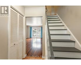 A staircase with a wooden floor and white steps.