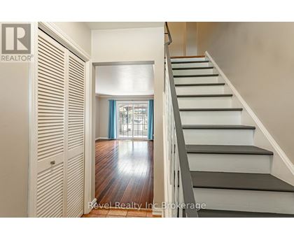 A staircase with a wooden floor and white steps.