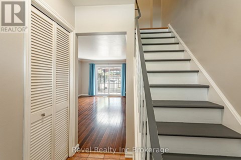 A staircase with a wooden floor and white steps.