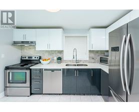 A modern kitchen with stainless steel appliances and white cabinets.