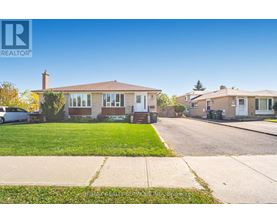 A realtor photo of a house with a car parked in front.