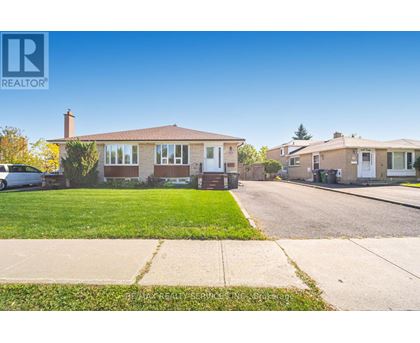 A realtor photo of a house with a car parked in front.