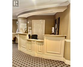 A reception area with a desk and a chair.