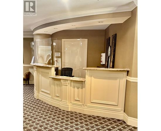 A reception area with a desk and a chair.