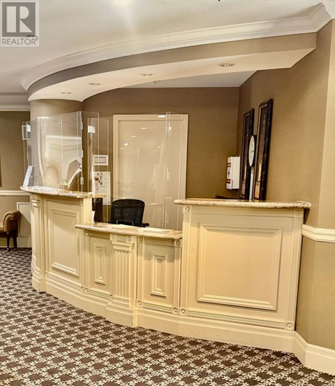 A reception area with a desk and a chair.