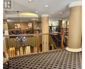 A large room with a staircase and a chandelier.