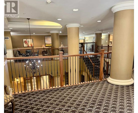 A large room with a staircase and a chandelier.