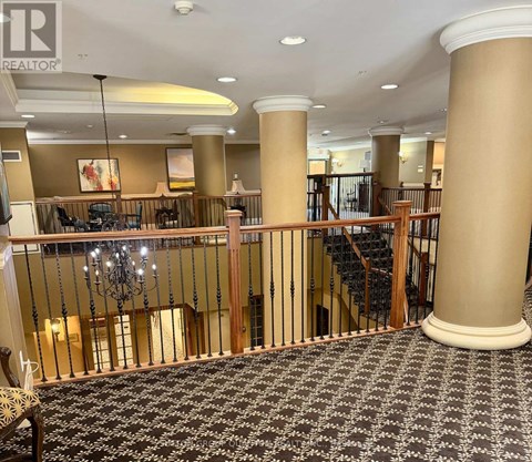 A large room with a staircase and a chandelier.