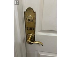 A door handle with a lock and a number 1103 on it.
