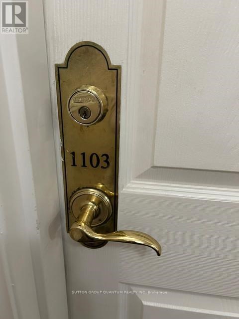 A door handle with a lock and a number 1103 on it.