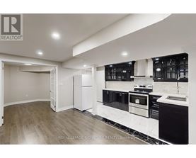 A modern kitchen with a sink and stove top oven.