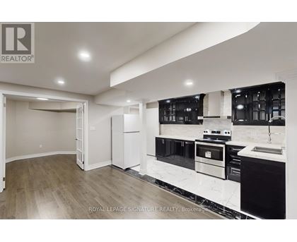 A modern kitchen with a sink and stove top oven.
