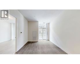 A spacious room with a door leading to another room.