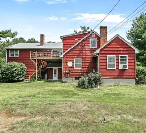 A red house with a white door and windows.