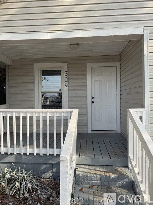 A white door with the number 209 on it.