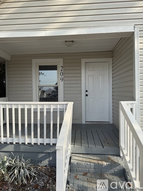 A white door with the number 209 on it.