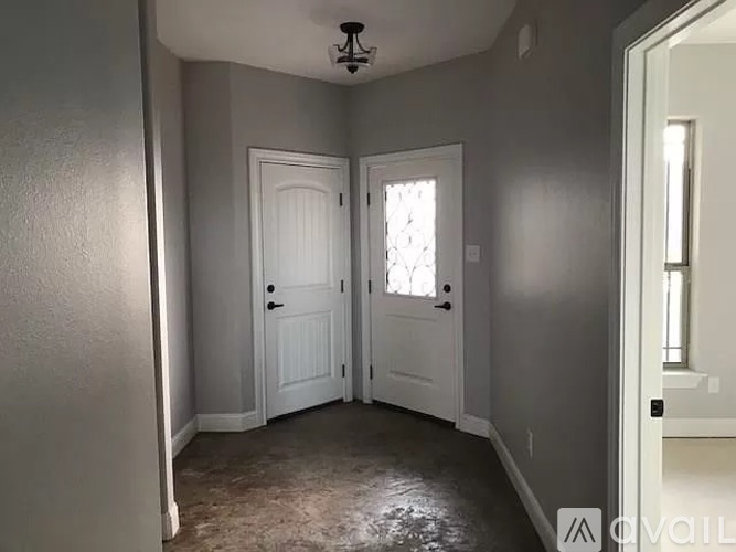 A room with two doors and a window.