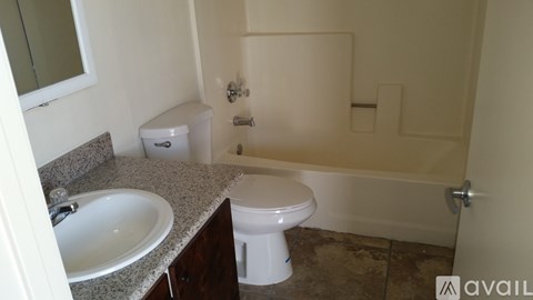 A bathroom with a toilet, sink, and bathtub.