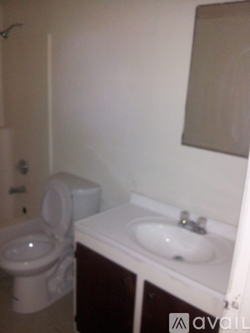 A white toilet sits next to a sink in a small bathroom.