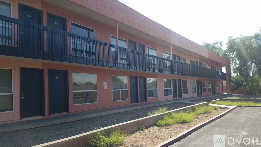 A building with balconies and doors is available for rent.