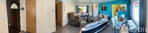 A living room with a couch and a chair.