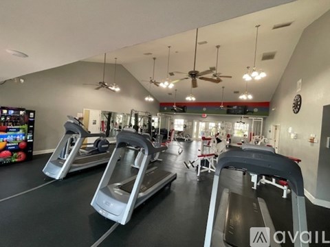 A gym with treadmills and elliptical machines.