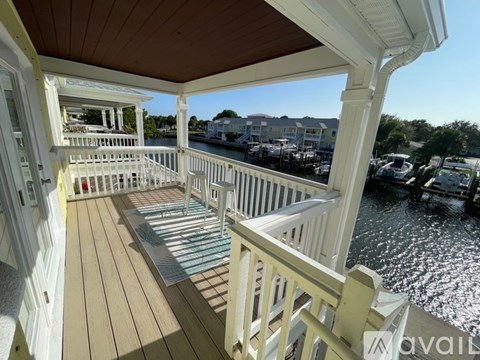 A balcony with a view of boats and buildings.